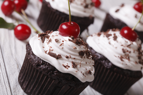Chocolate cupcakes with cream and cherry