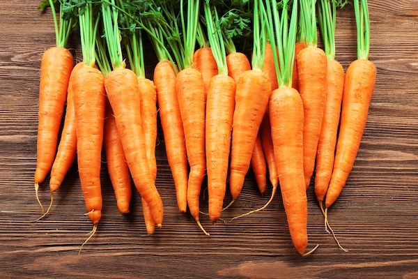 Bunch of carrots with wood background