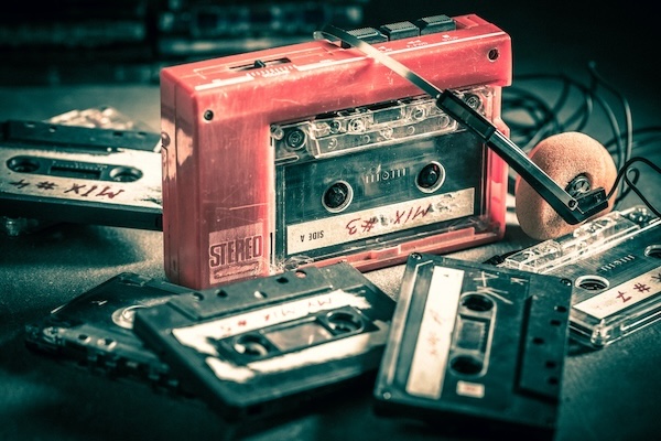 Old cassette tape with headphones and walkman